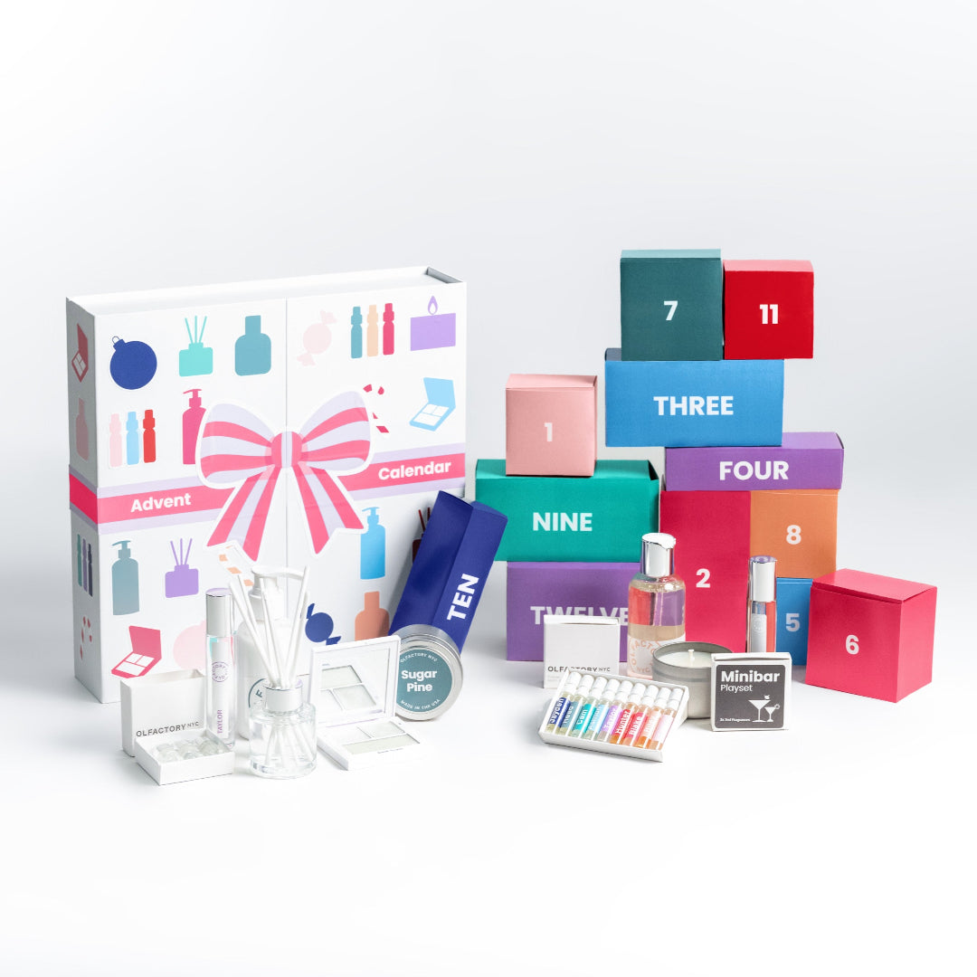 A minimalist desk with a lamp, plant, laptop, notebooks, and coffee beans.