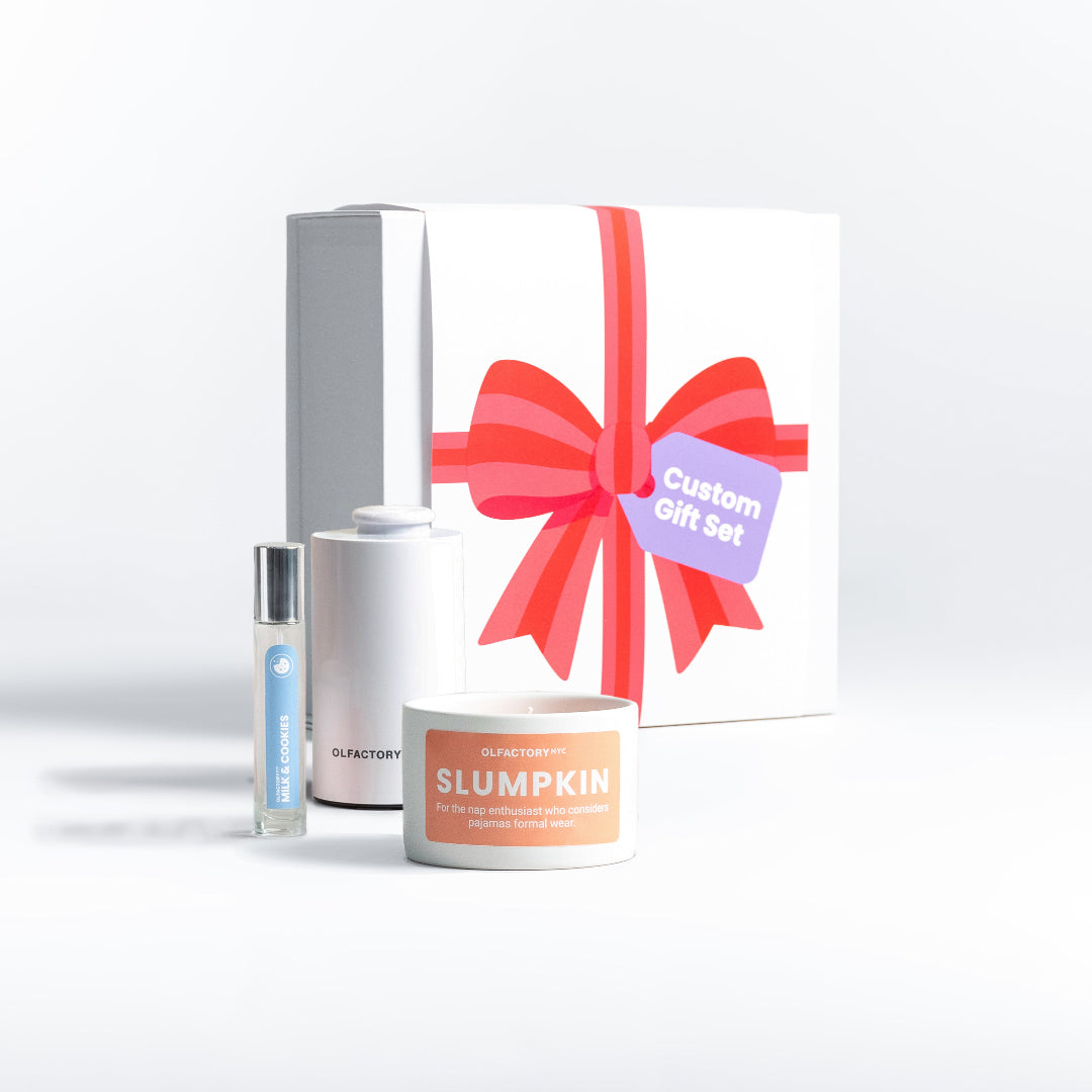 A minimalist desk with a lamp, plant, laptop, notebooks, and coffee beans.