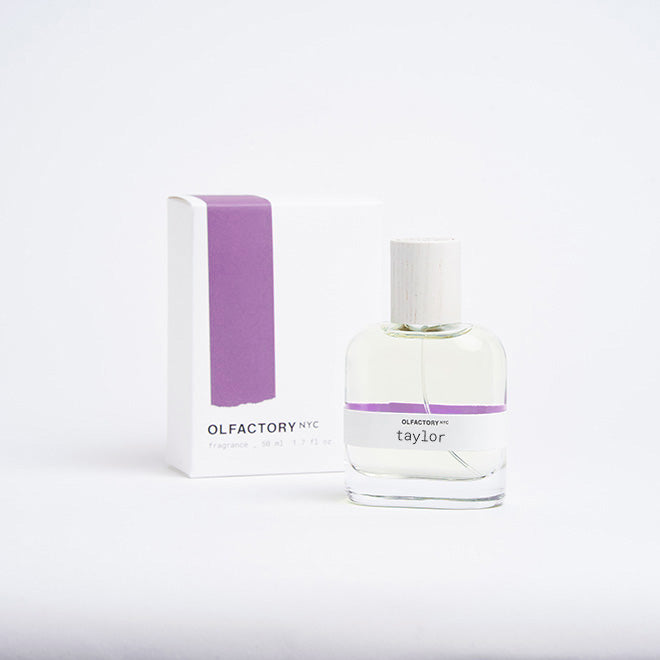 A minimalist desk with a lamp, plant, laptop, notebooks, and coffee beans.