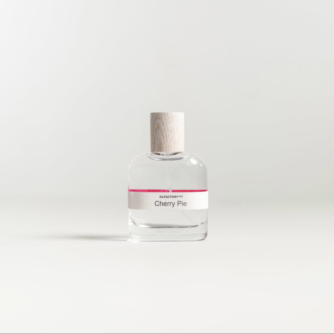 A minimalist desk with a lamp, plant, laptop, notebooks, and coffee beans.