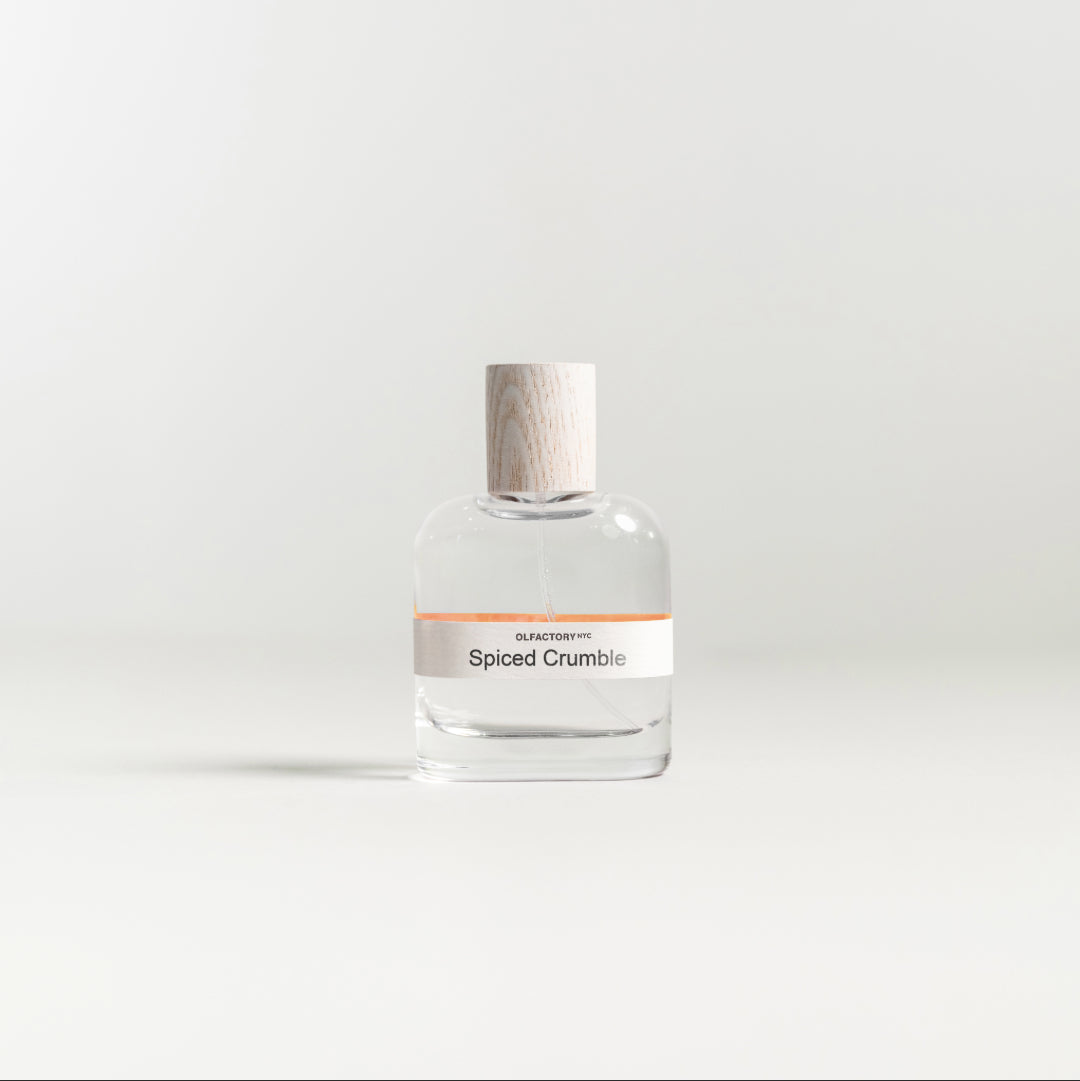 A minimalist desk with a lamp, plant, laptop, notebooks, and coffee beans.