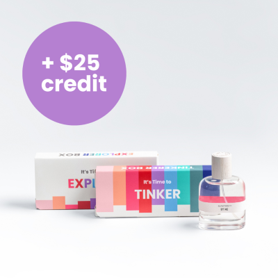 A minimalist desk with a lamp, plant, laptop, notebooks, and coffee beans.